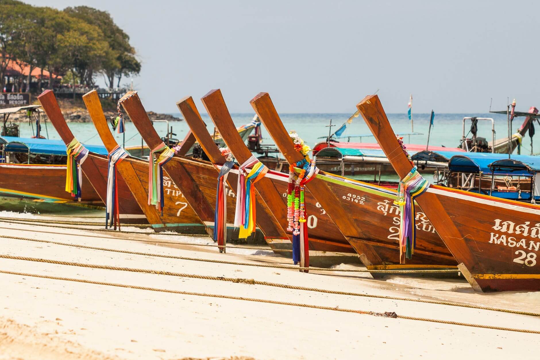 brown wooden docked boat at daytime