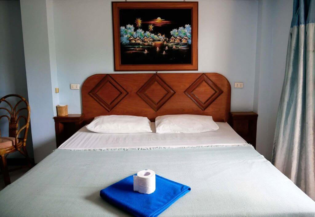 Picture of made bed in deluxe ac room at KYN muay thai