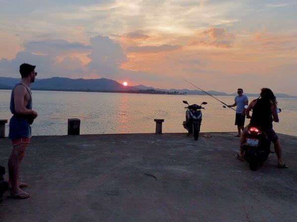 picture of three males fishing at koh yao noi dock